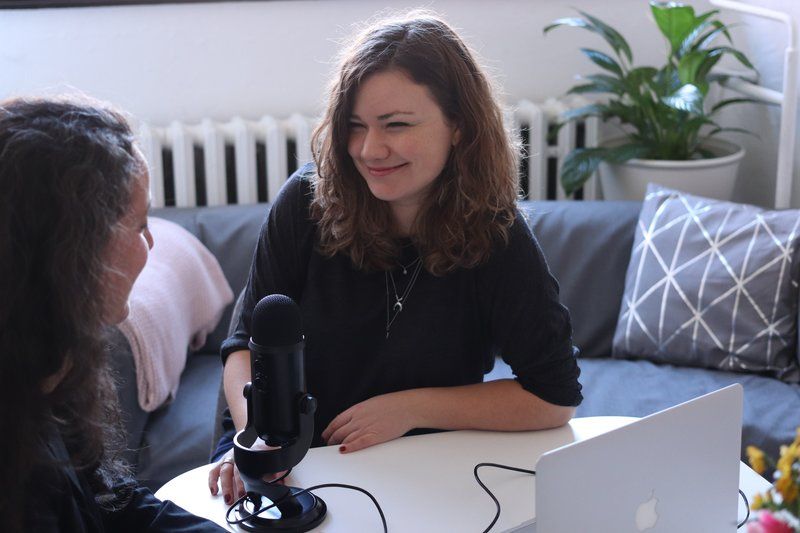 Two women interview in front microphone