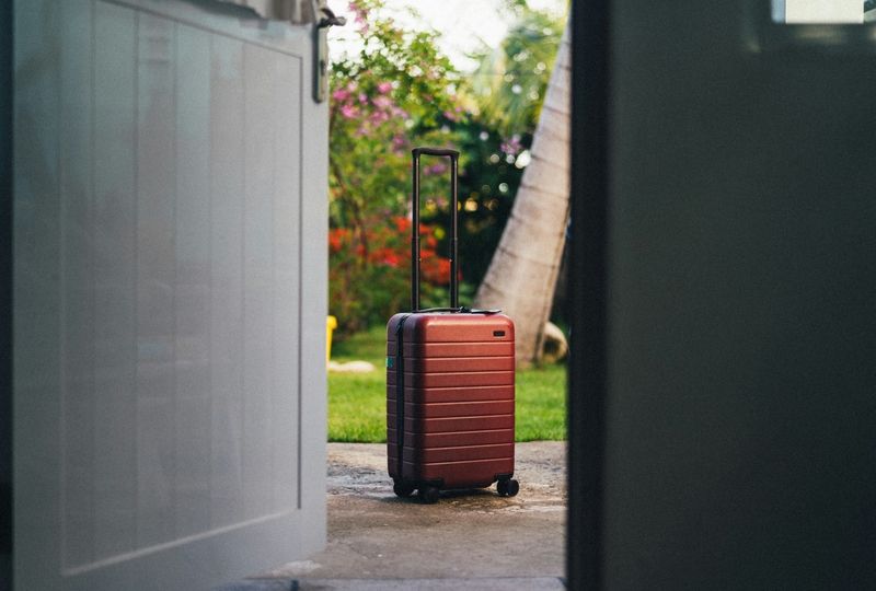 red roller bag on the driveway