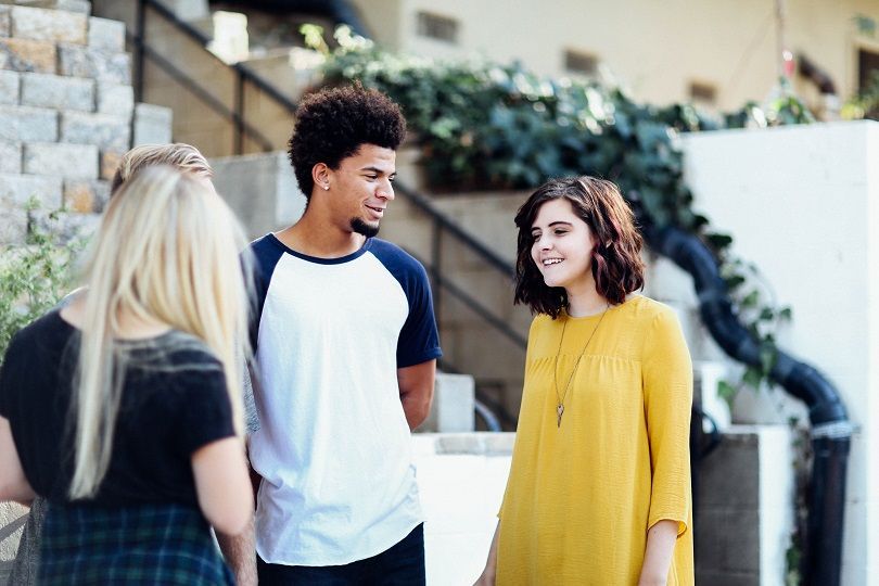 A boy and two girls speak Italian