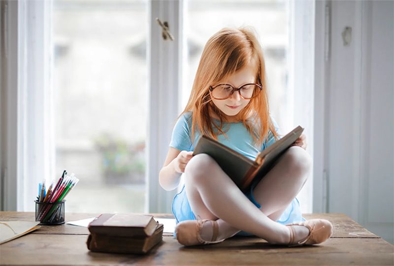 A Girl is learning Japanese by reading a book