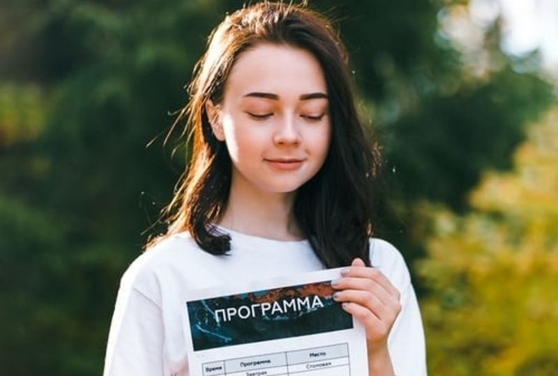 A Russian Girl Holds a List of Basic Russian Travel Words