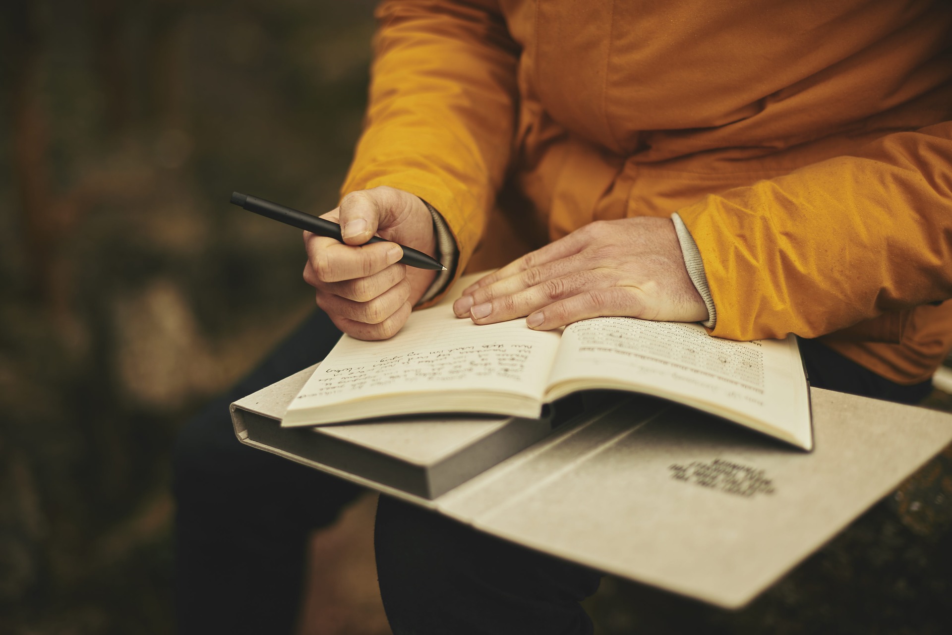 man writing in a notebook