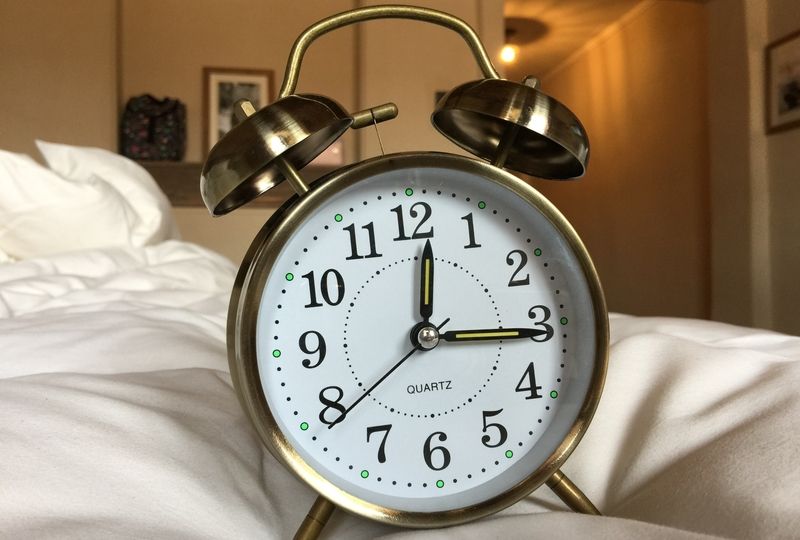 alarm clock on bed