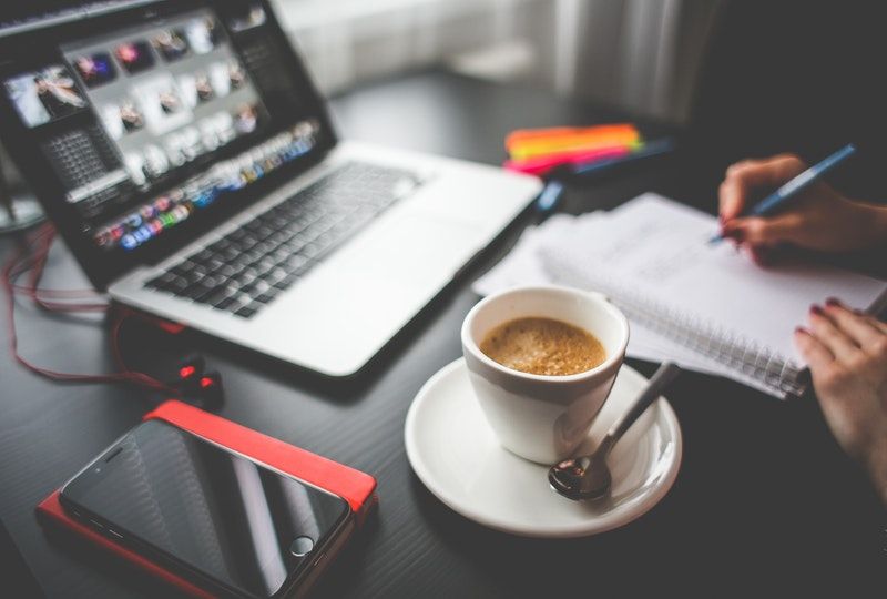 person studying with laptop notebook and coffee