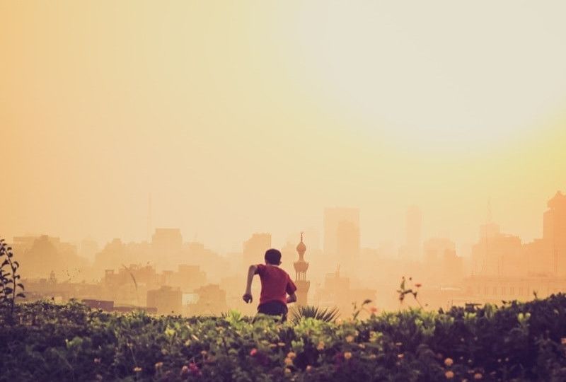 boy in field running away