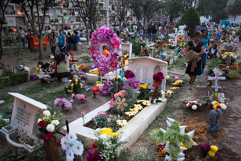 cemetery during day of the dead full of colors