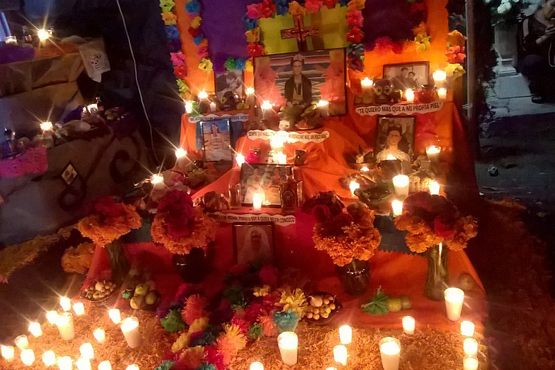 day of the dead altar at night with candles