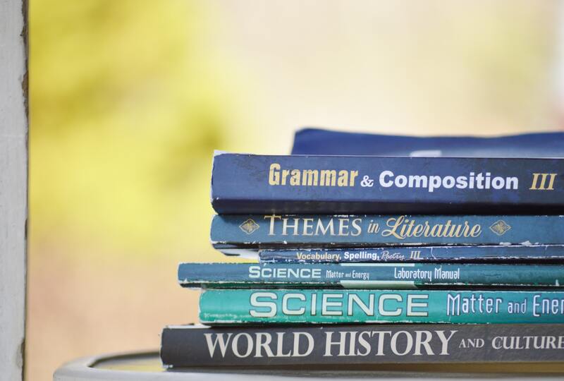 english books stacked on top of each other