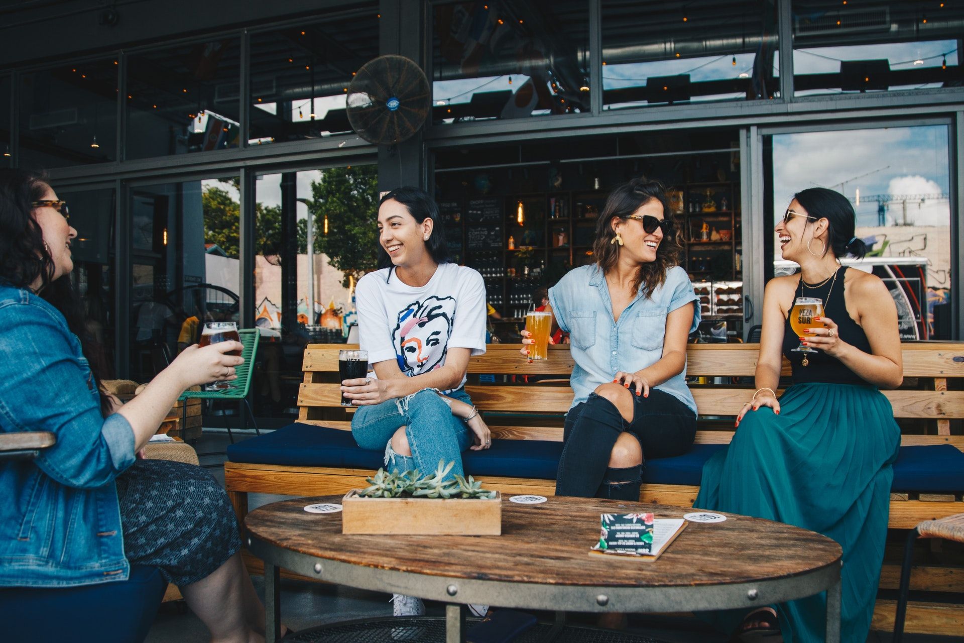 four women sitting on benches