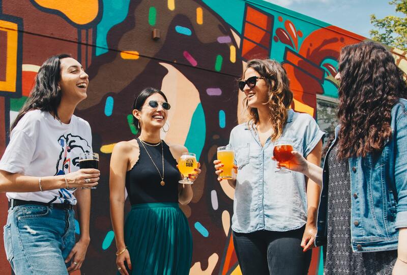 four women speaking to each other and laughing