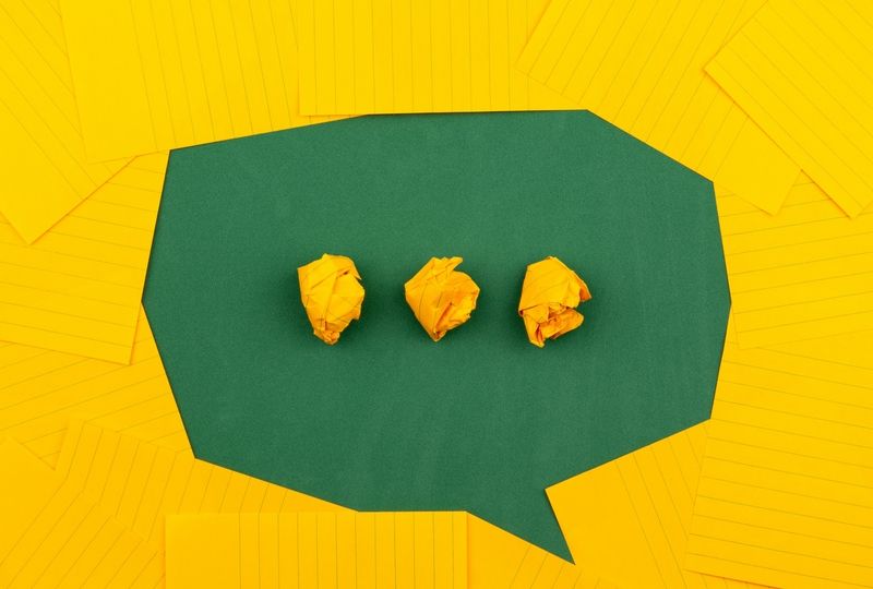 Green speech bubble with yellow ellipsis