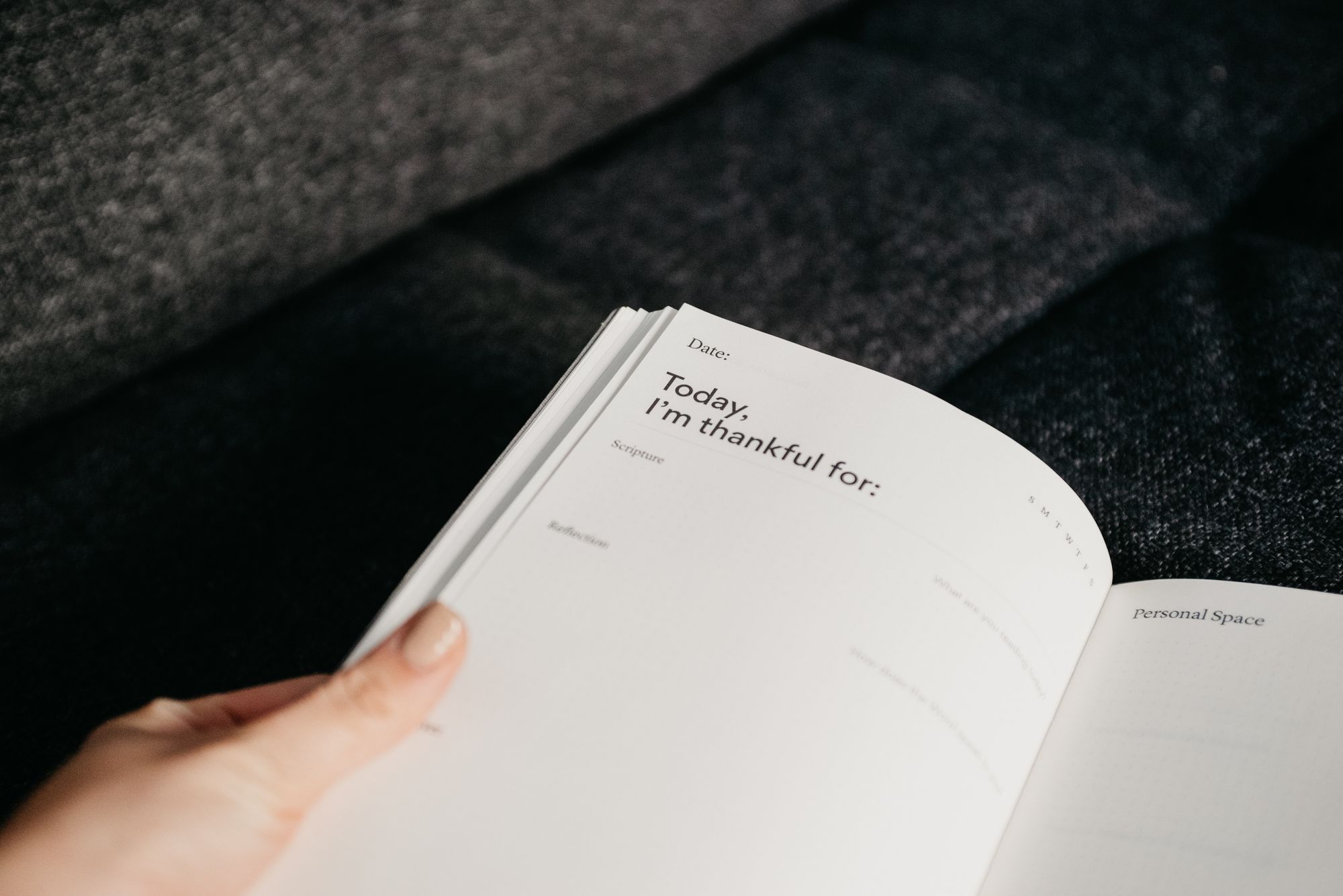 book on a table with a hand