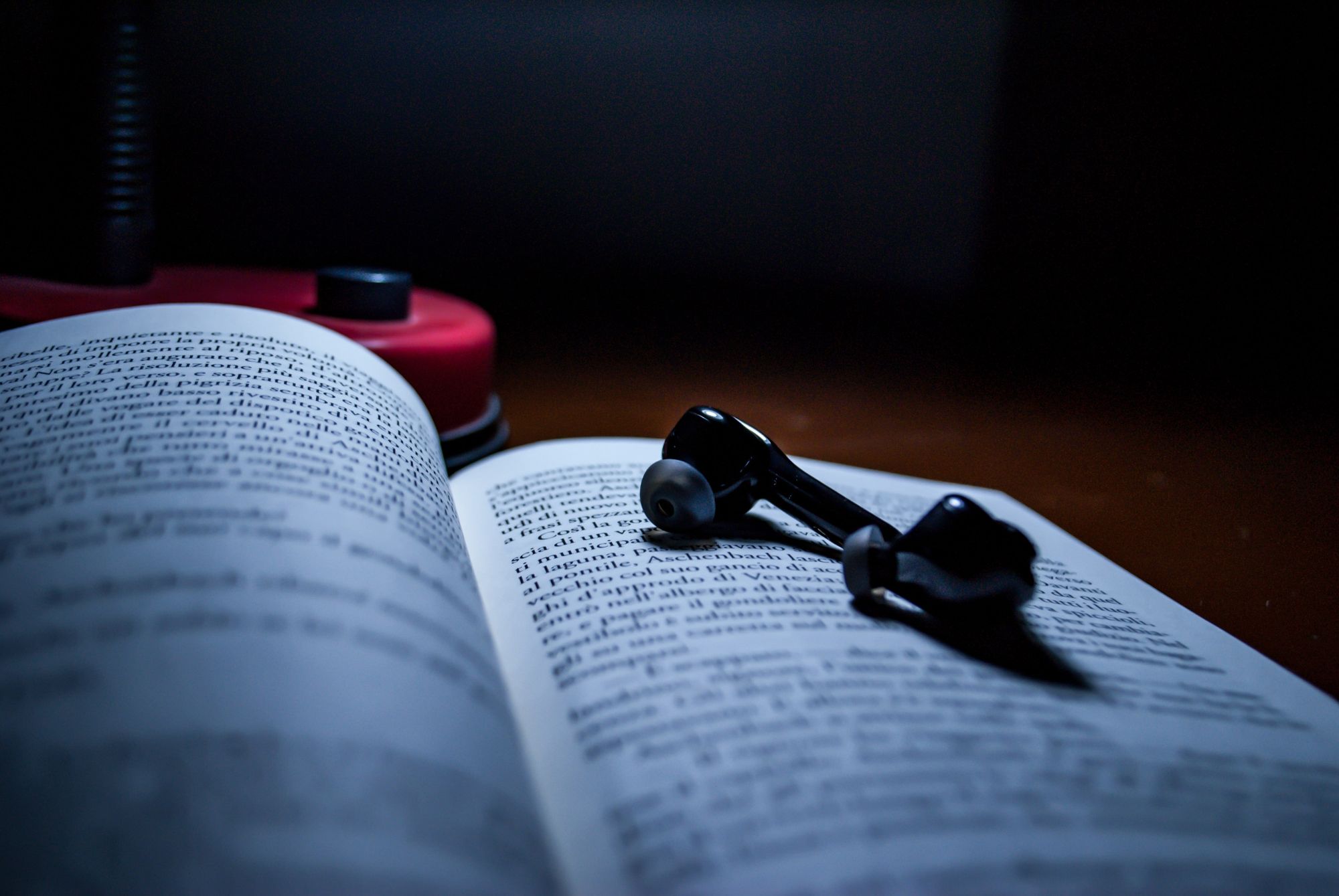 Earphones on top of a book