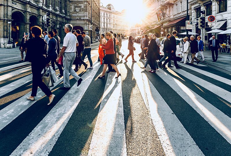 People crossing the road at a busy intersection