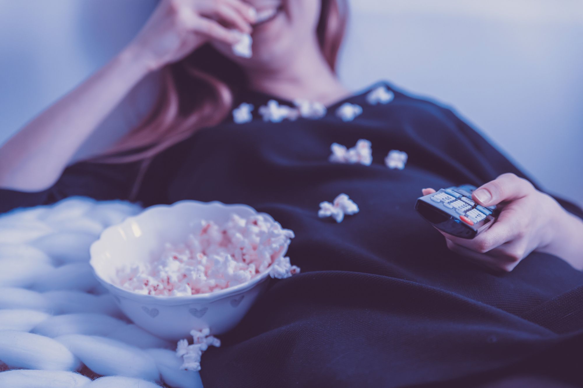 Woman eating popcorn and watching a movie