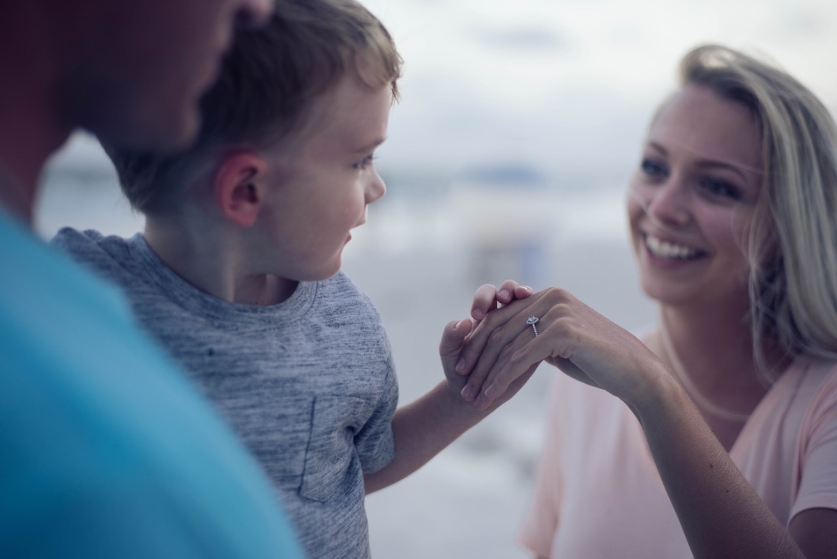 Little boy holding his mom's hand