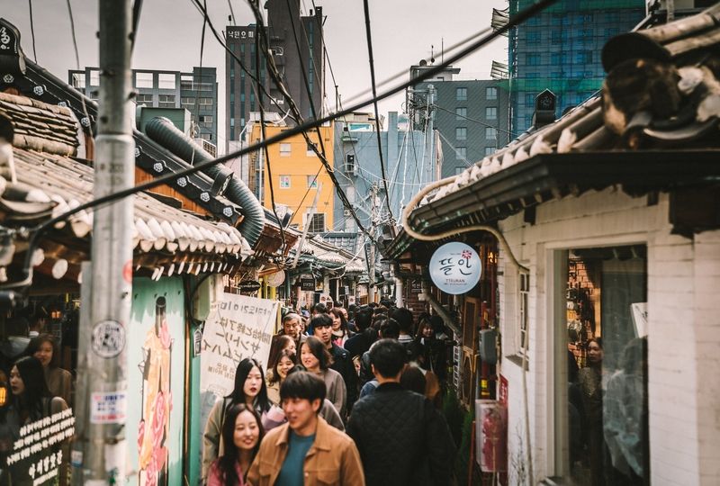 Koreans walking down a crowded alleyway