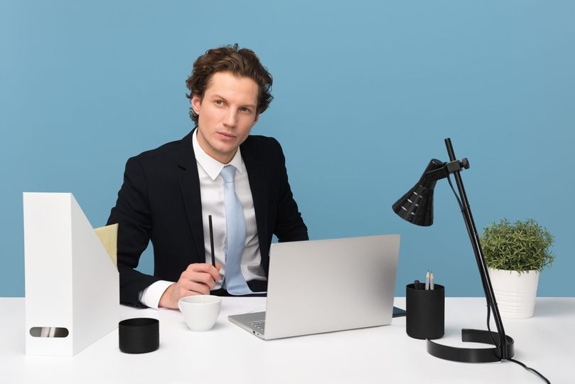 Man at desk studying language alone