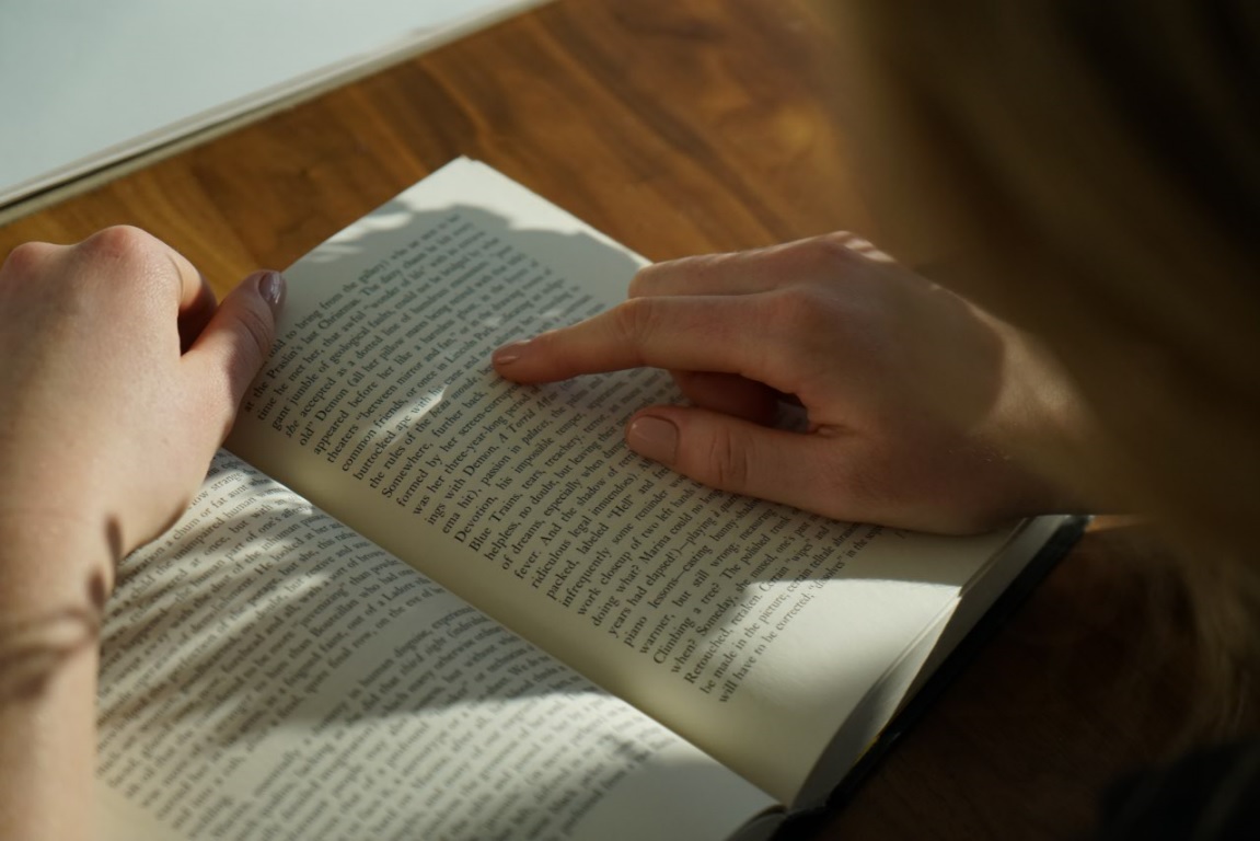 man carefully reading a book