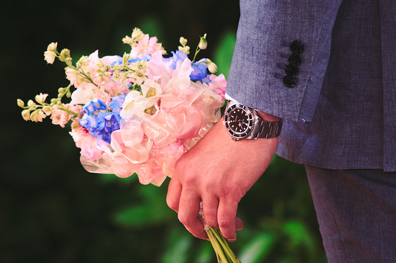 Man With Watch Holding Flowers