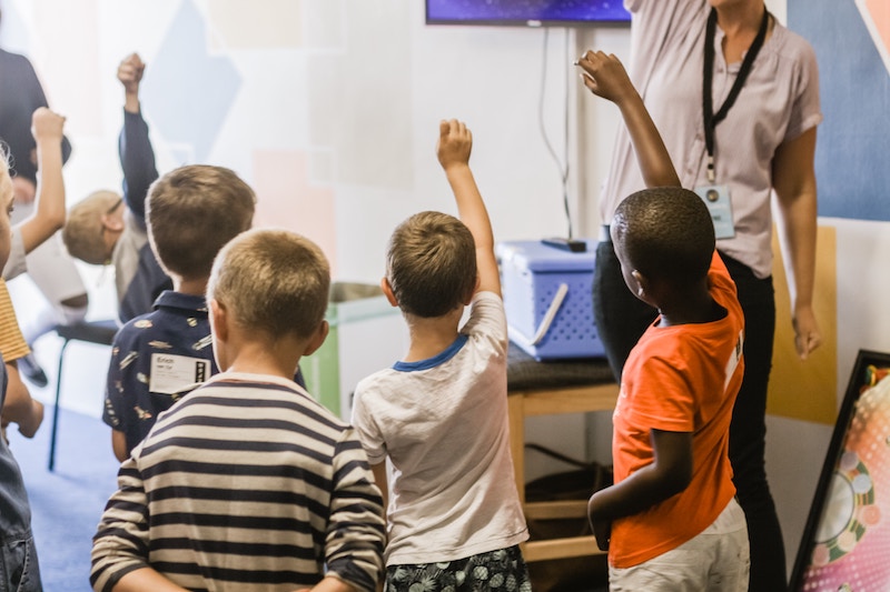 Kids Standing Around Teacher