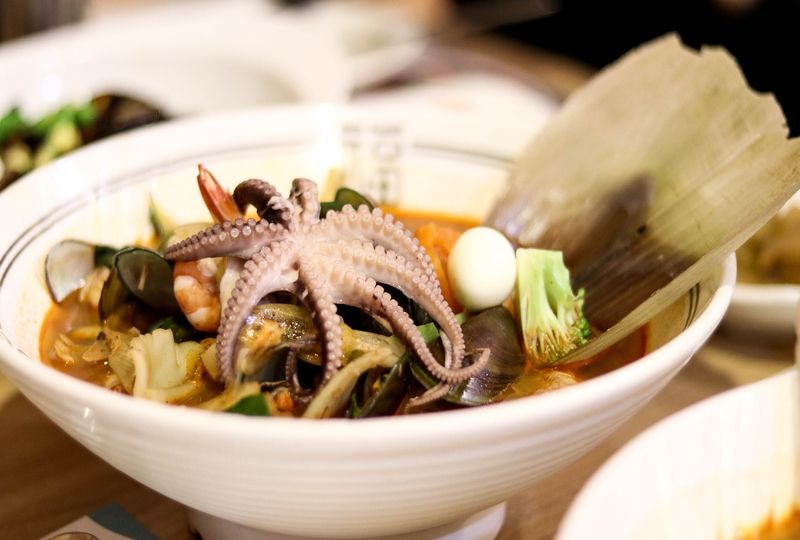 Octopus soup in white bowl