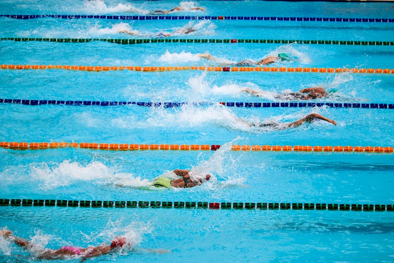 Swimmers racing in a pool.