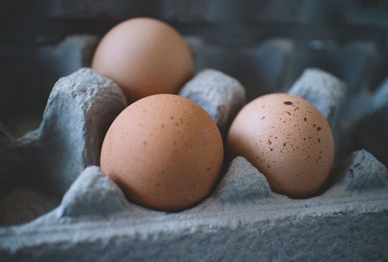 three eggs in a carton