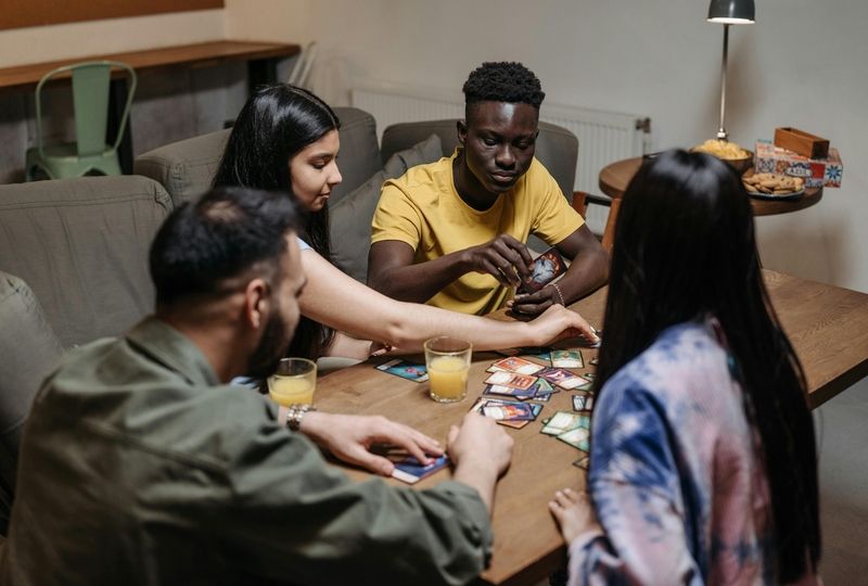 four friends playing a card game together