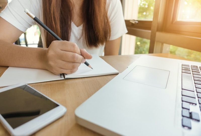 woman writing on paper