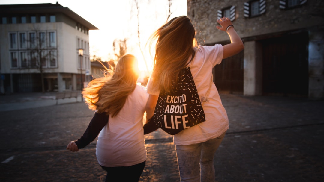 Walking on the street towards sunset