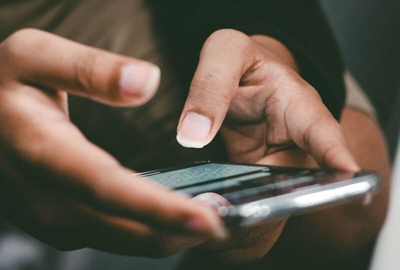 Hands holding a cellphone and texting