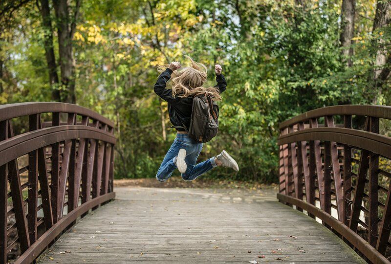 girl happily jumping up