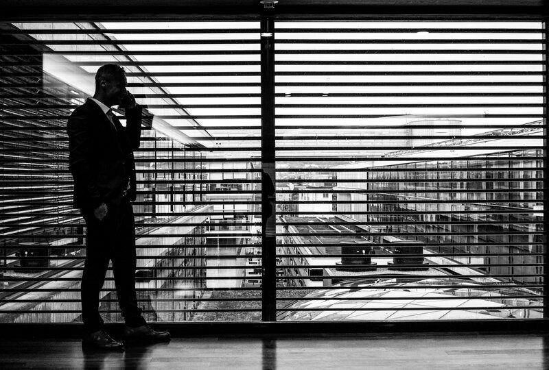 black and white artsy photo of a businessman on a call