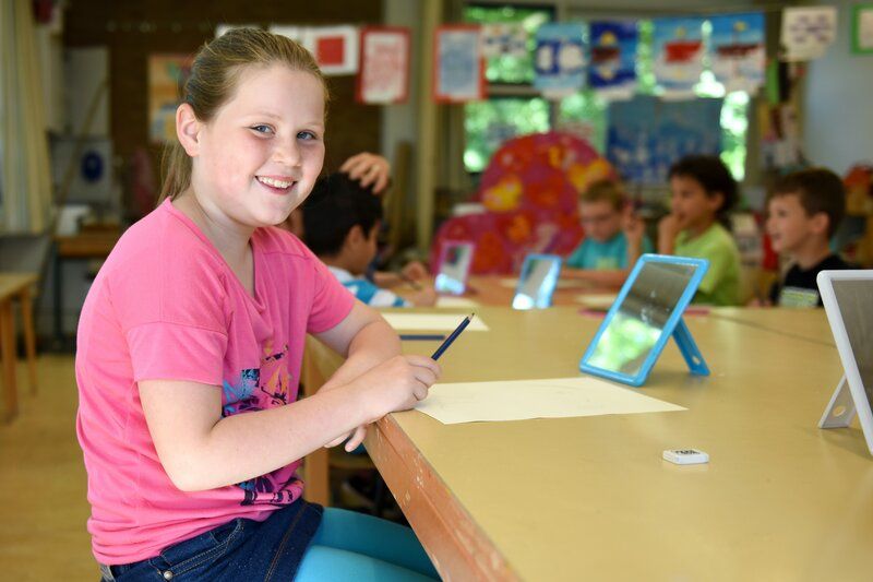 young girl smiling in a classroom