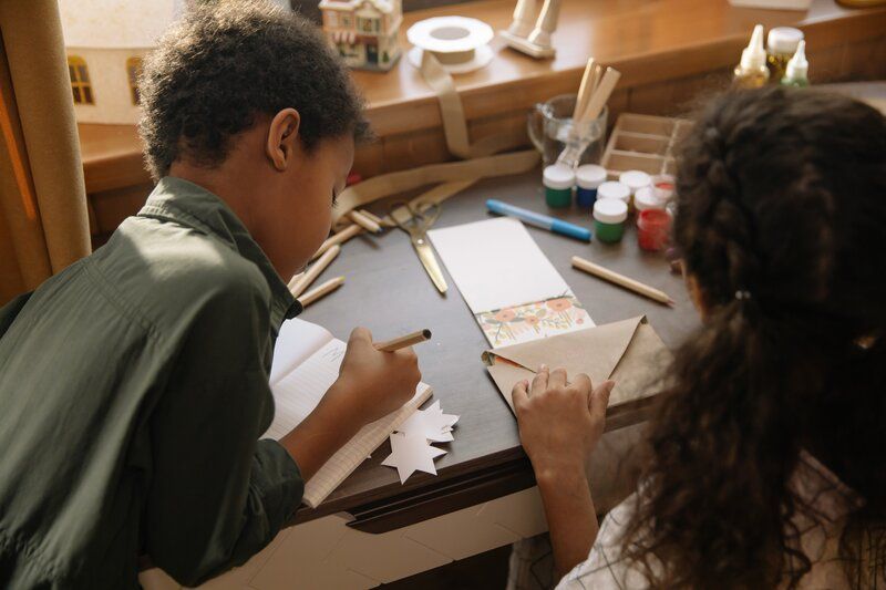 two children writing letters