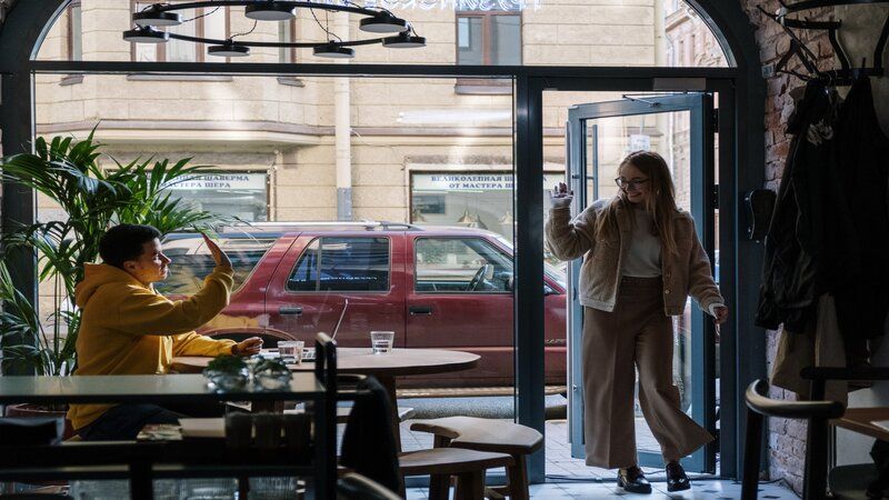 a woman meeting a friend at a coffee shop