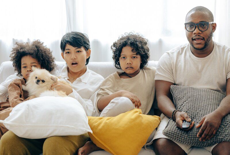 a family sitting down to watch a movie