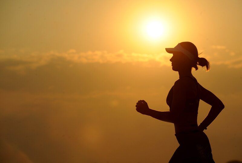 woman running listening to an English podcast