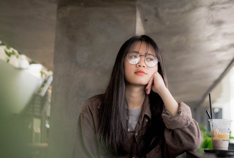 woman looking out a window contently