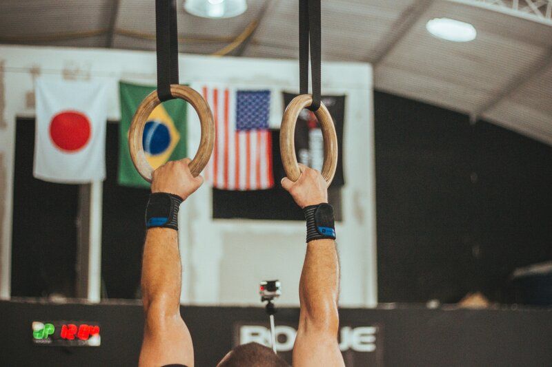 a gymnast holding onto rings