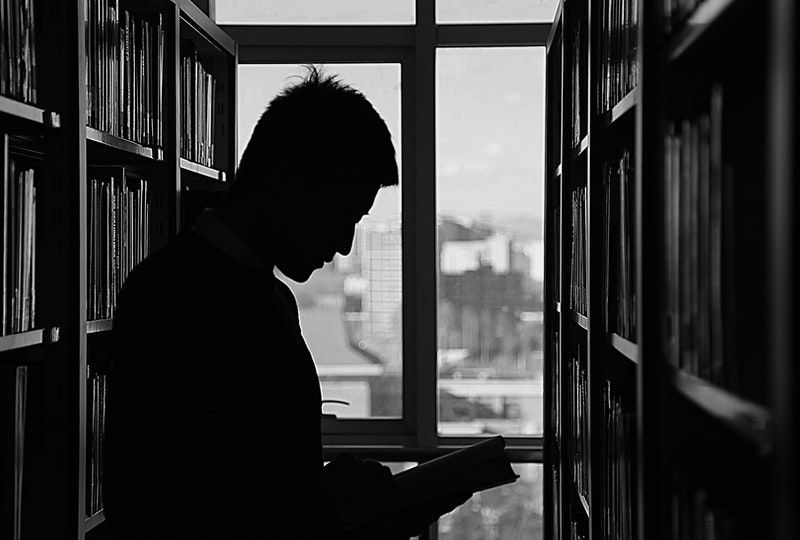 silhouette of man reading