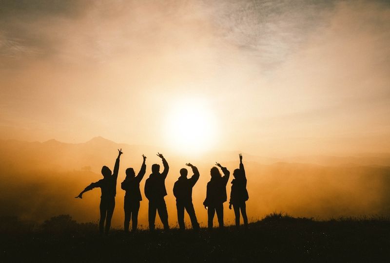 Silhouette of six people on a mountain