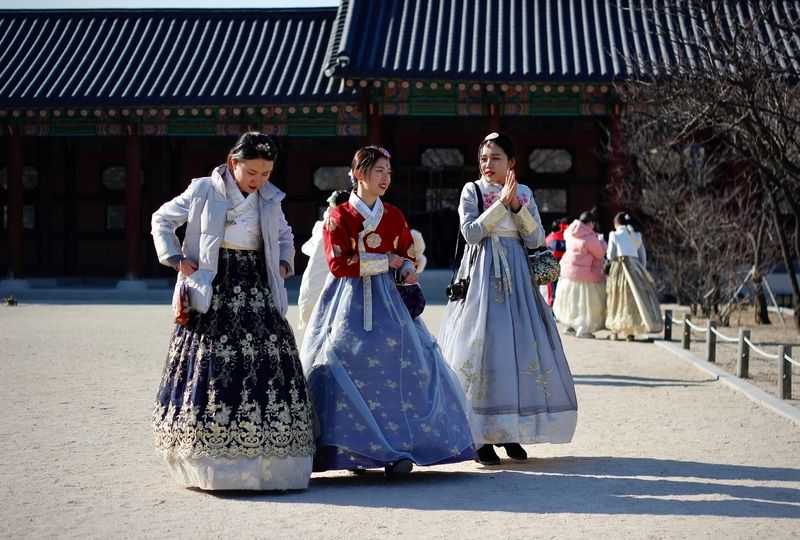 Three women in traditional Korean dresses