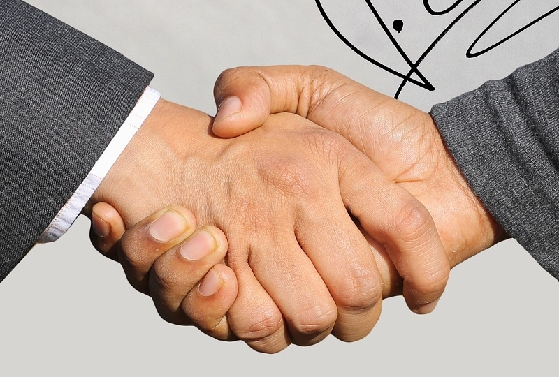 Handshake in front of signature