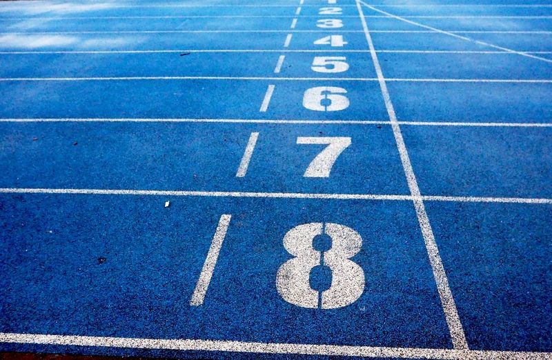 a blue race track with painted numbers