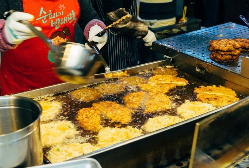 Woman cooking Korean pancakes