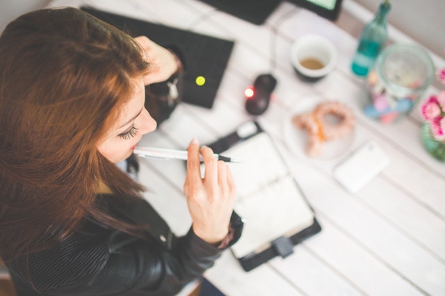 woman at a desk writing