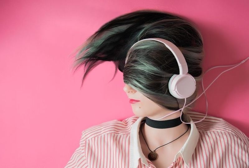 A girl laying down with headphone on