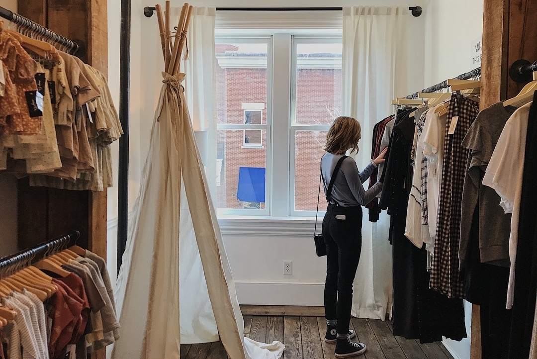 Woman-Standing-Selecting-Clothes-in-Store